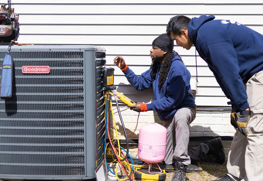 professional HVAC heating installation job with technician installing furnace or heat system components in residential setting