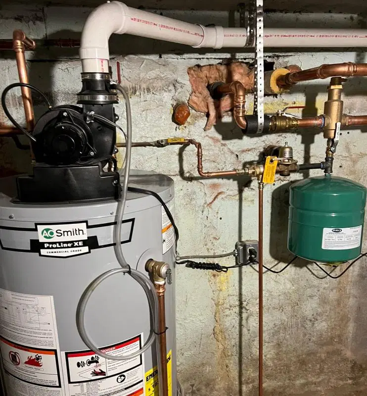 hot water heater installation in Elkridge MD with AO Smith ProLine XE tank and connected copper piping in basement